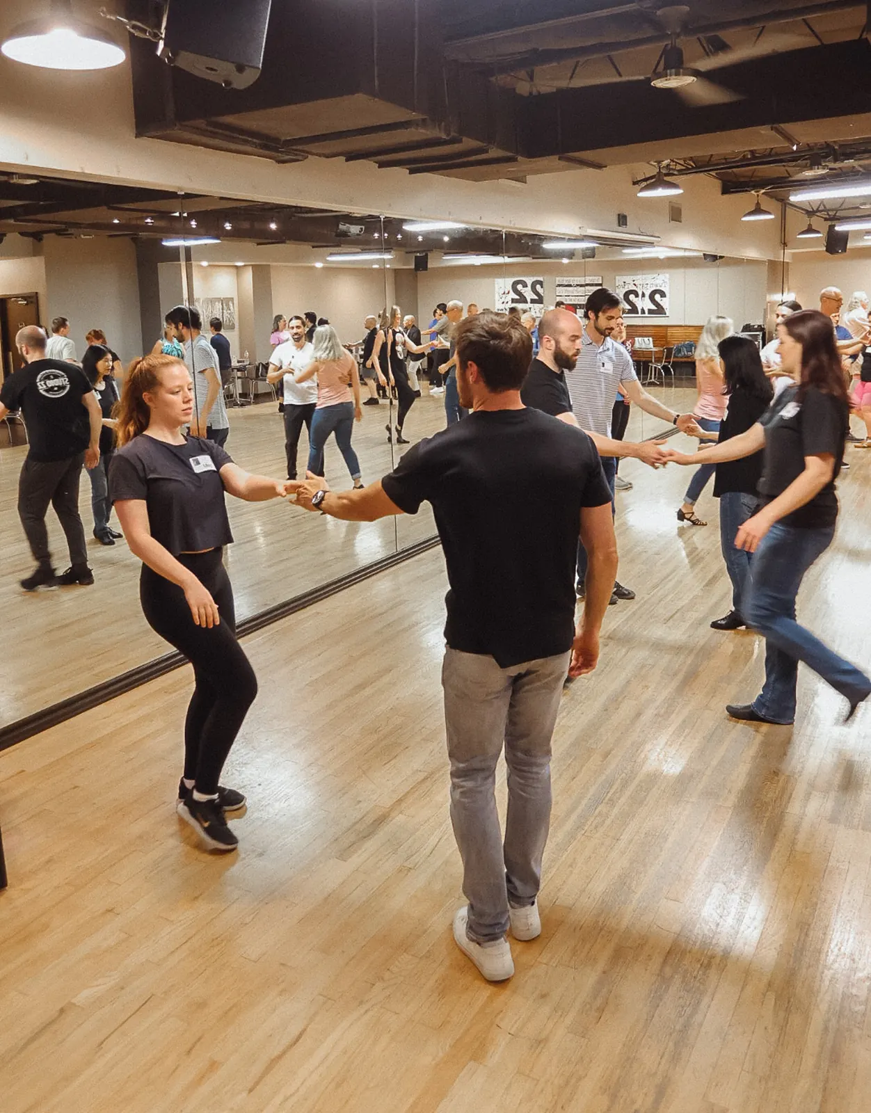 Partner dance students smiling during class