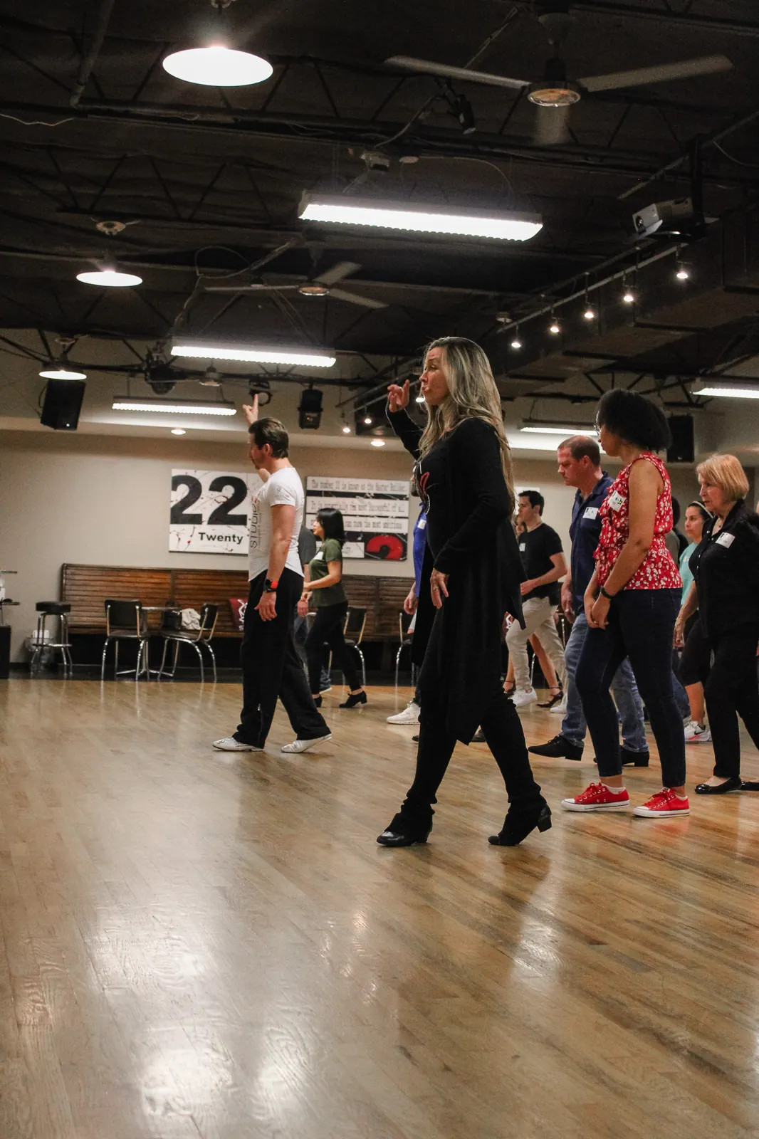 Instructors leading a full group dance class at Studio 22 Dallas