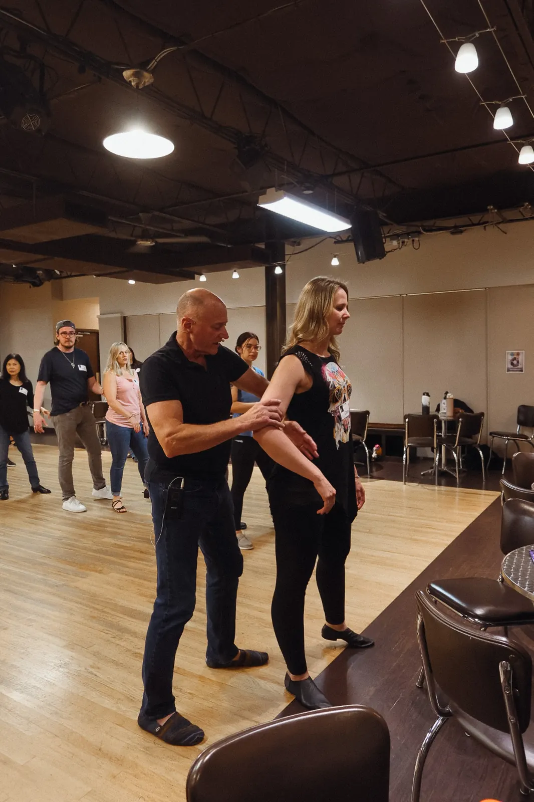 West Coast Swing instructor guiding a student during class